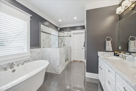 a bathroom with a tub sink and mirror