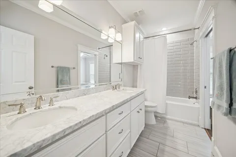 a bathroom with a granite countertop sink mirror bathtub and shower