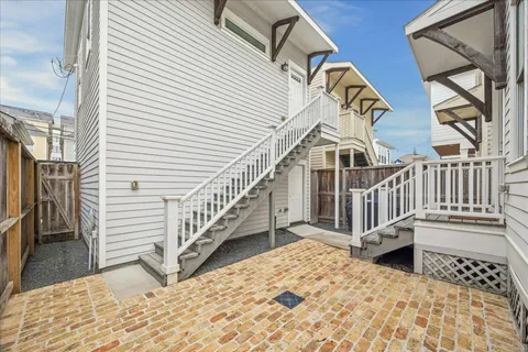 a view of a house with wooden stairs and a balcony
