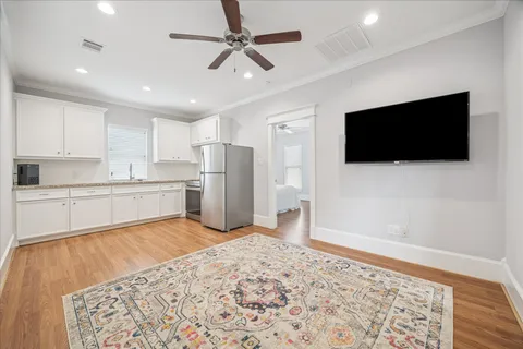 a view of a kitchen with a flat screen tv and refrigerator