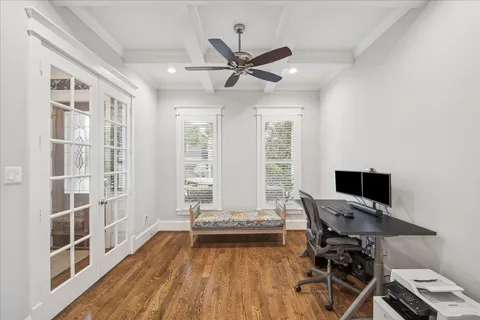 a view of a workspace with furniture and a window