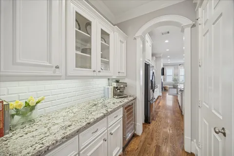 a bathroom with a granite countertop sink a mirror and shower