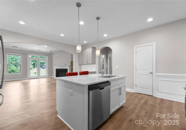 a kitchen with a stove and a wooden floor