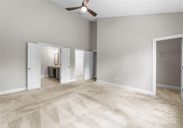 a view of an empty room with a kitchen