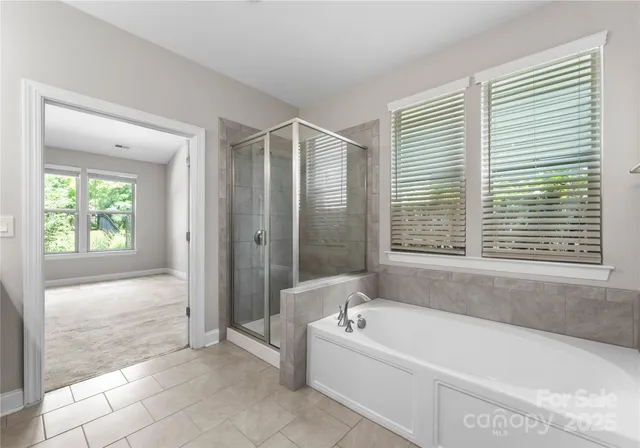 a spacious bathroom with a bathtub and a shower