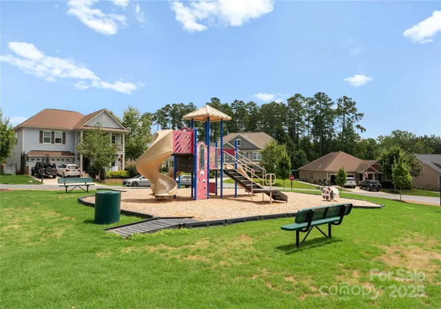 a view of a chairs and table in patio with swimming pool
