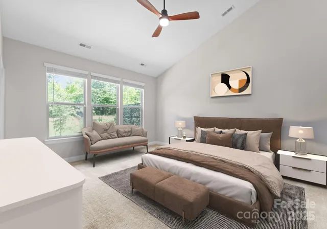 a bedroom with a bed and a couch