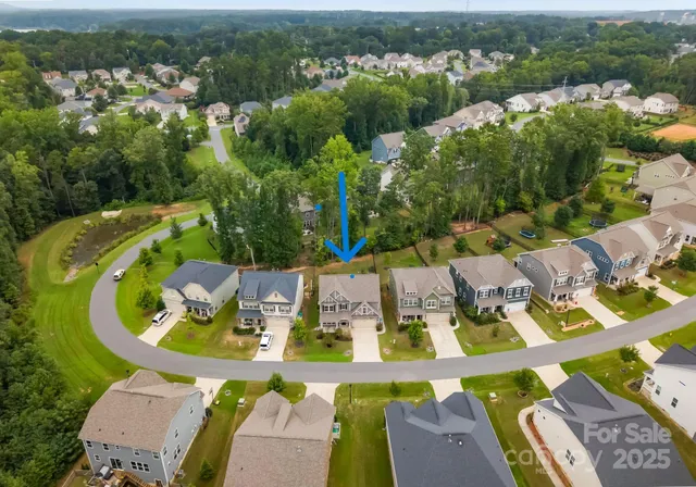 an aerial view of residential house with outdoor space and swimming pool