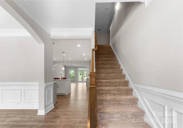 a view of entryway and hall with wooden floor