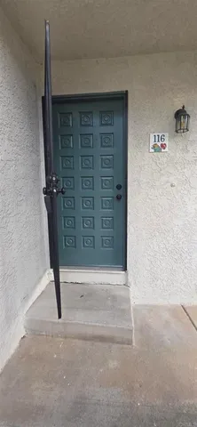 a kitchen with granite countertop a refrigerator and a stove top oven
