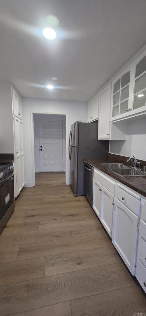 2306 Altisma Way, Unit 116 Carlsbad, CA 92009 - Photo 17 of 17 a kitchen with granite countertop a refrigerator and a stove top oven