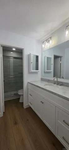 a spacious bathroom with double sink and mirror