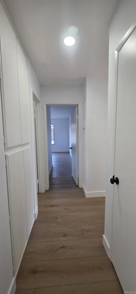 2306 Altisma Way, Unit 116 Carlsbad, CA 92009 - Photo 7 of 17 a view of empty room with wooden floor