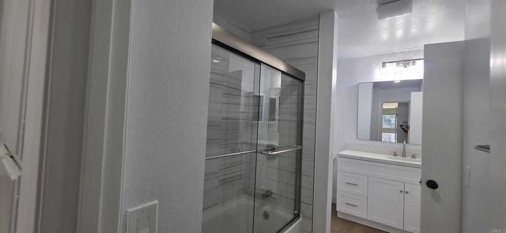 2306 Altisma Way, Unit 116 Carlsbad, CA 92009 - Photo 10 of 17 a bathroom with a shower and a sink