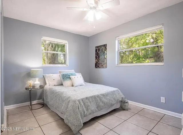 an empty room with cabinet and windows