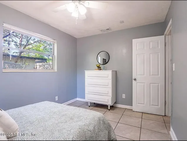 a kitchen with a sink cabinets and wooden floor