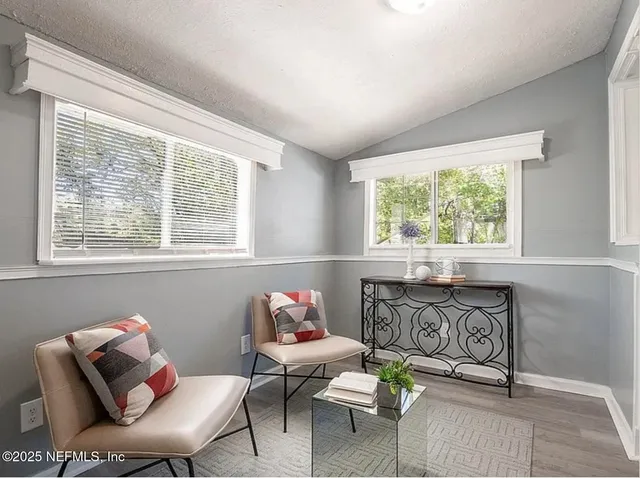 a view of backyard of house with green space