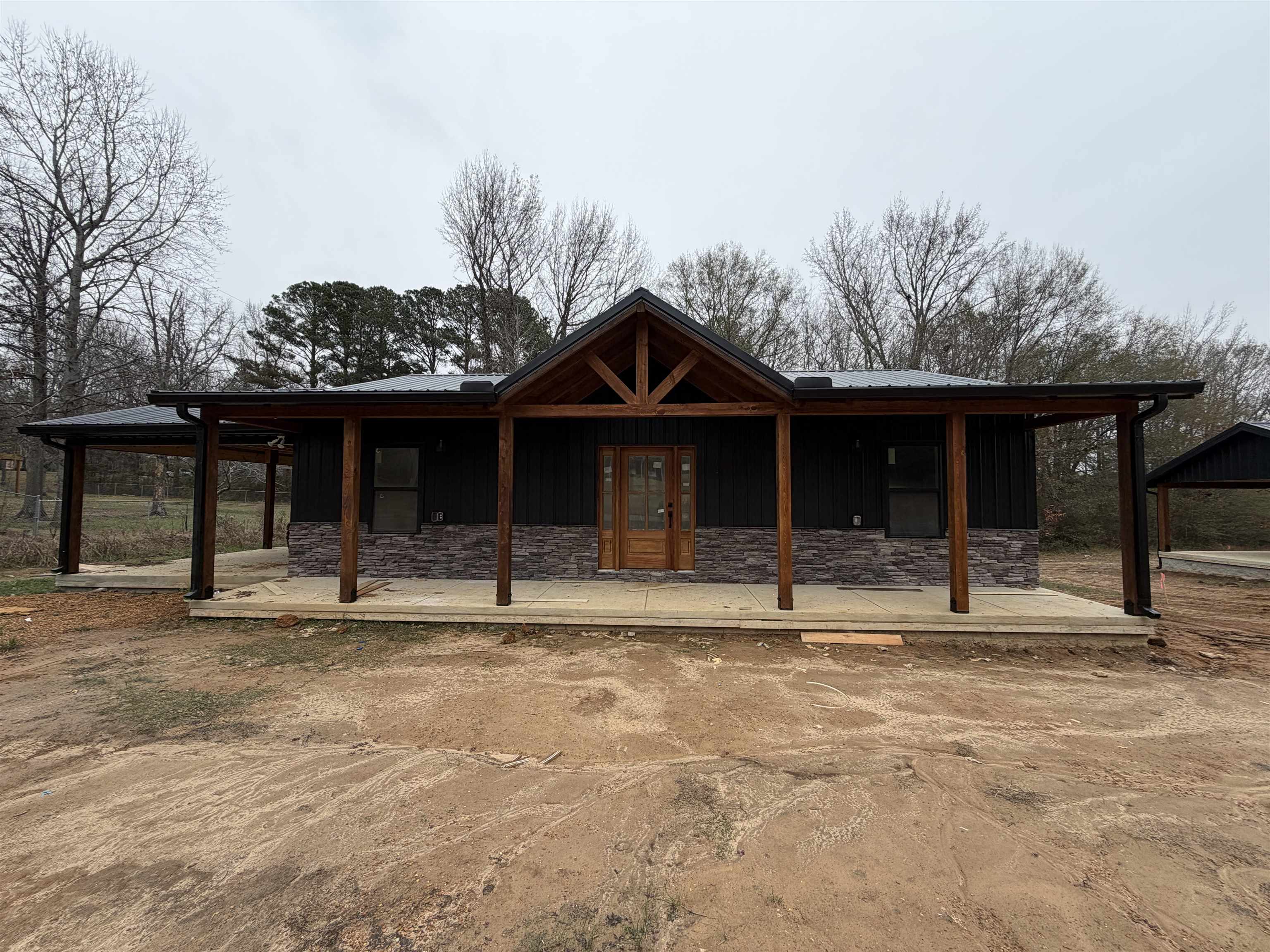 a view of a house with a large window and a yard