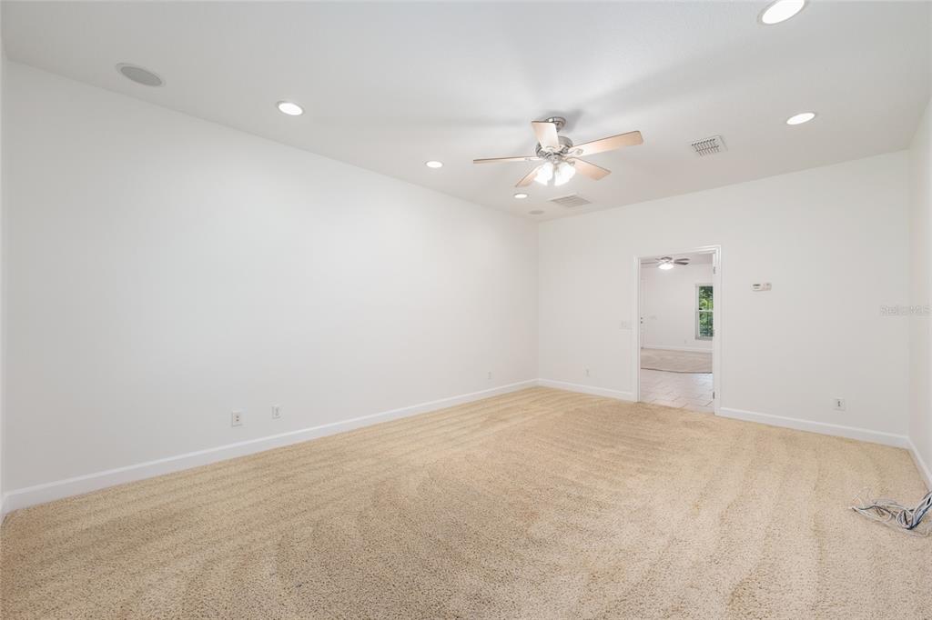 4735 Southeast 112th Street Road Belleview, FL 34420 - Photo 39 of 73 an empty room with fan and a ceiling fan