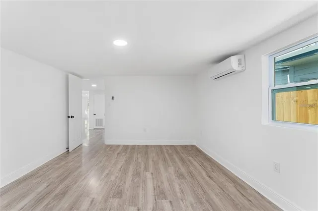 a view of a room with wooden floor and brick walls