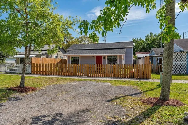 a front view of a house with a yard and trees