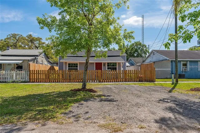 a view of backyard with a table and chairs and potted plants