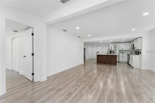 a view of a kitchen with wooden floor