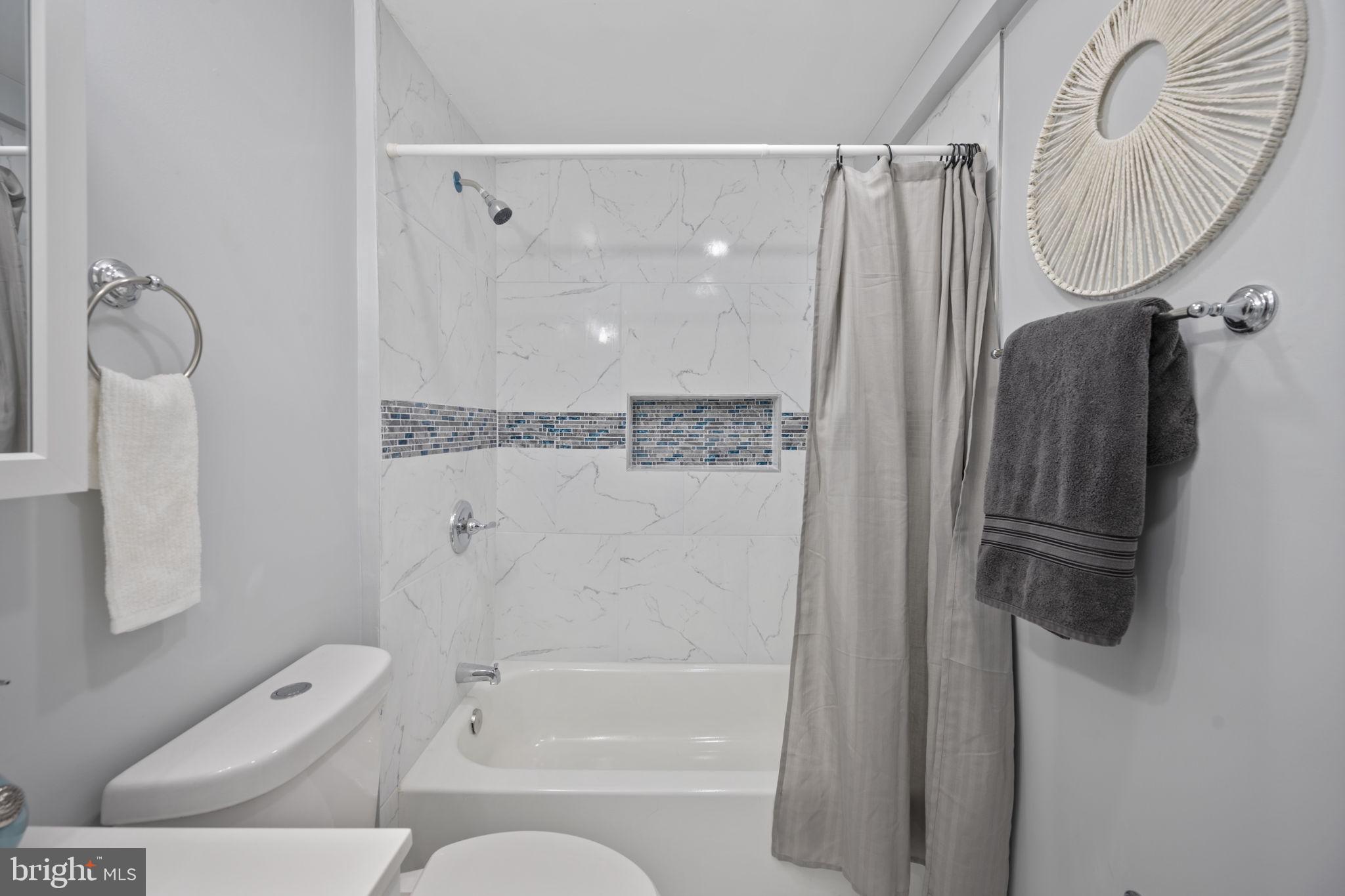 511 Riverside Drive Baltimore, MD 21221 - Photo 13 of 39 a bathroom with a shower a toilet and a shower