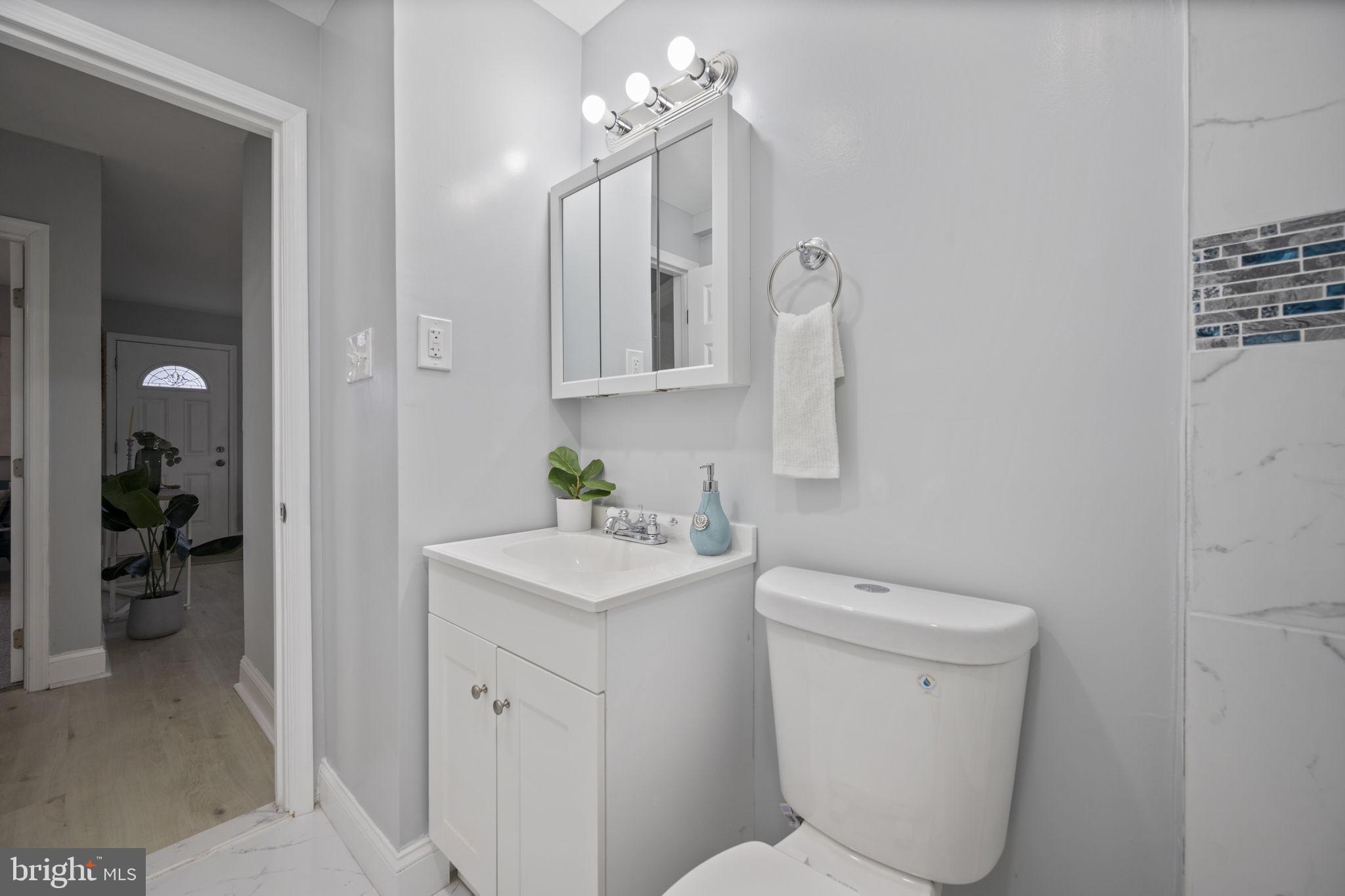 511 Riverside Drive Baltimore, MD 21221 - Photo 14 of 39 a bathroom with a toilet sink and mirror