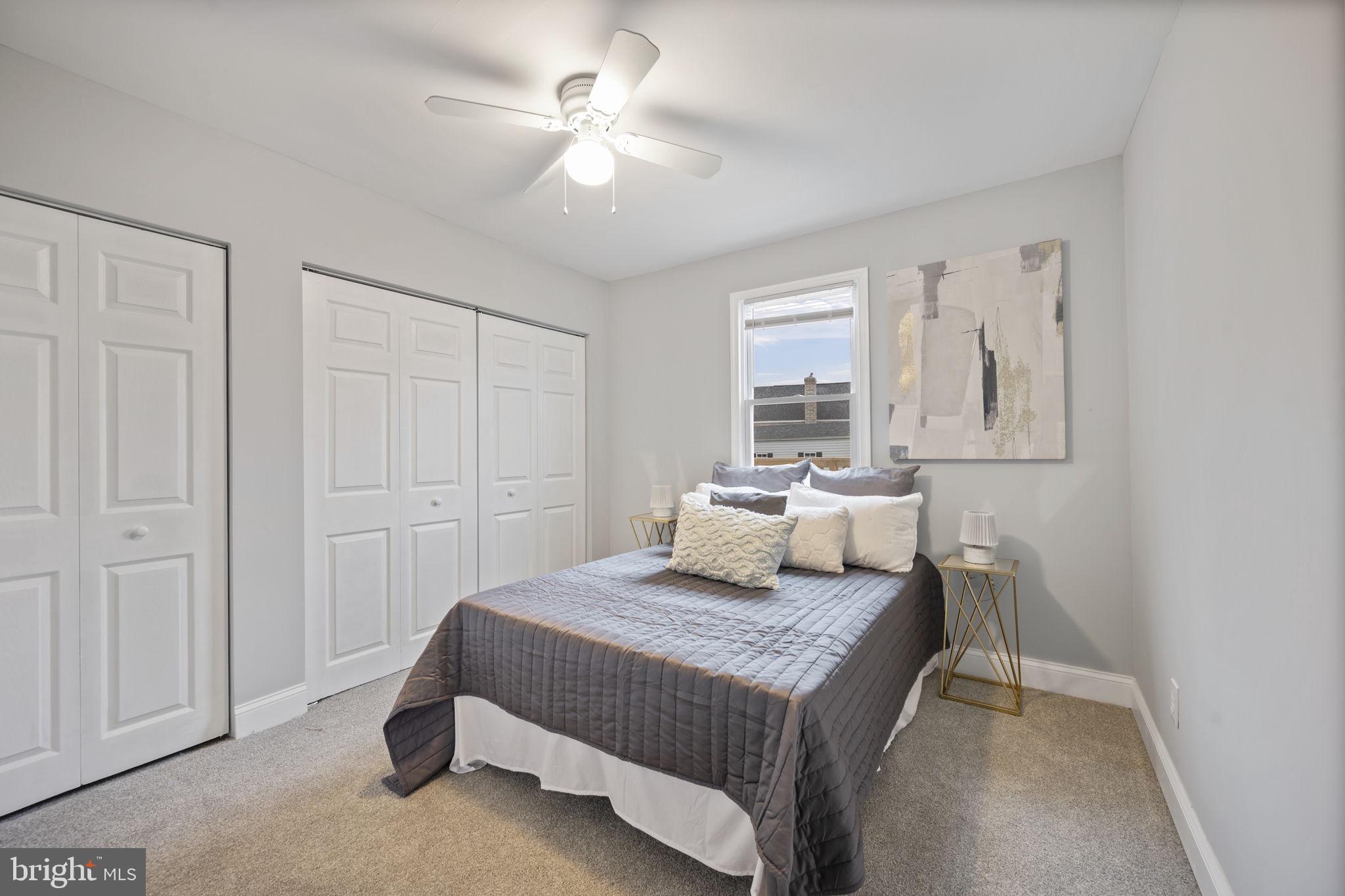 511 Riverside Drive Baltimore, MD 21221 - Photo 18 of 39 a bedroom with a large bed and a chandelier