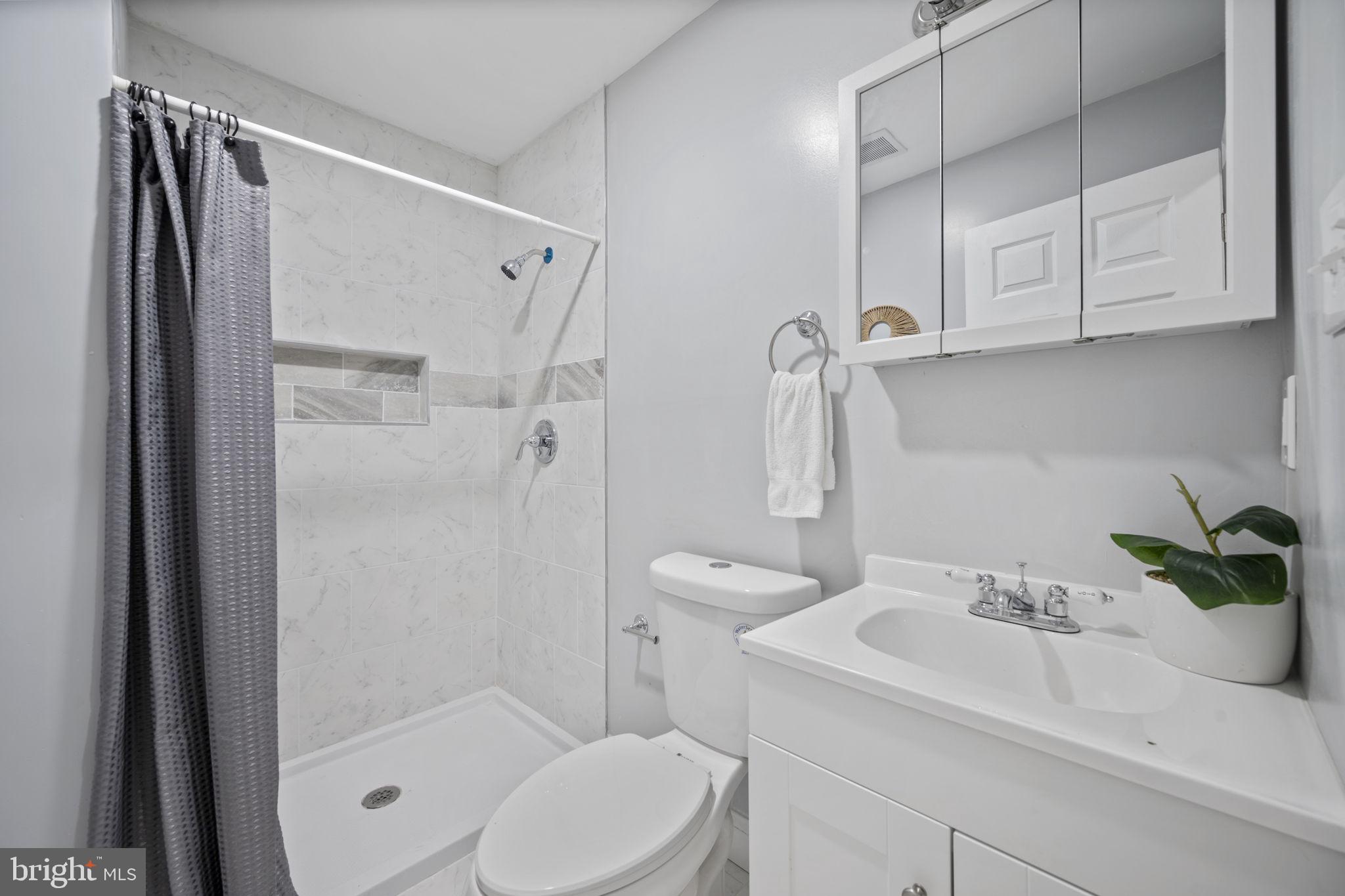 511 Riverside Drive Baltimore, MD 21221 - Photo 21 of 39 a bathroom with a sink toilet and shower