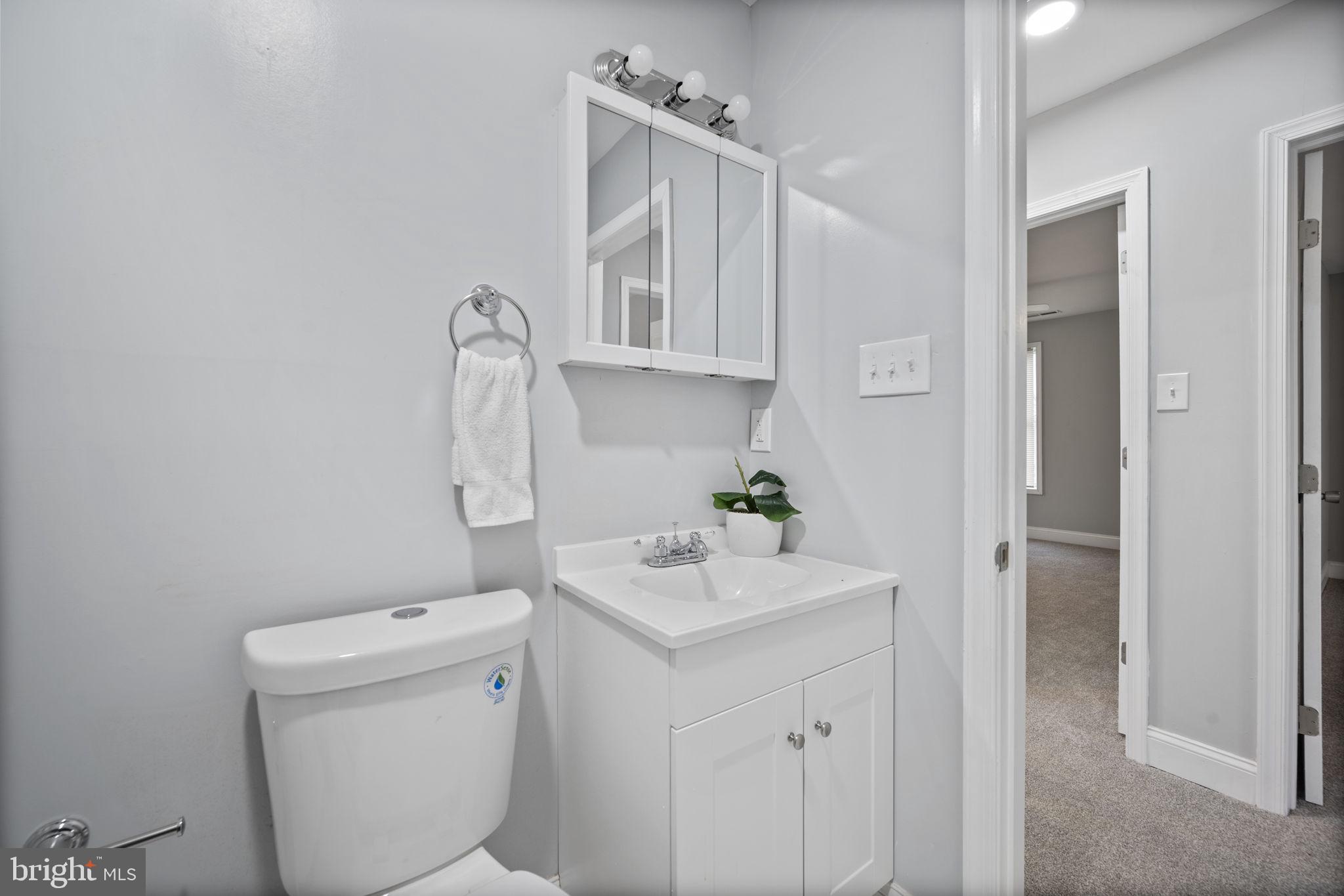 511 Riverside Drive Baltimore, MD 21221 - Photo 22 of 39 a bathroom with a sink a toilet and vanity