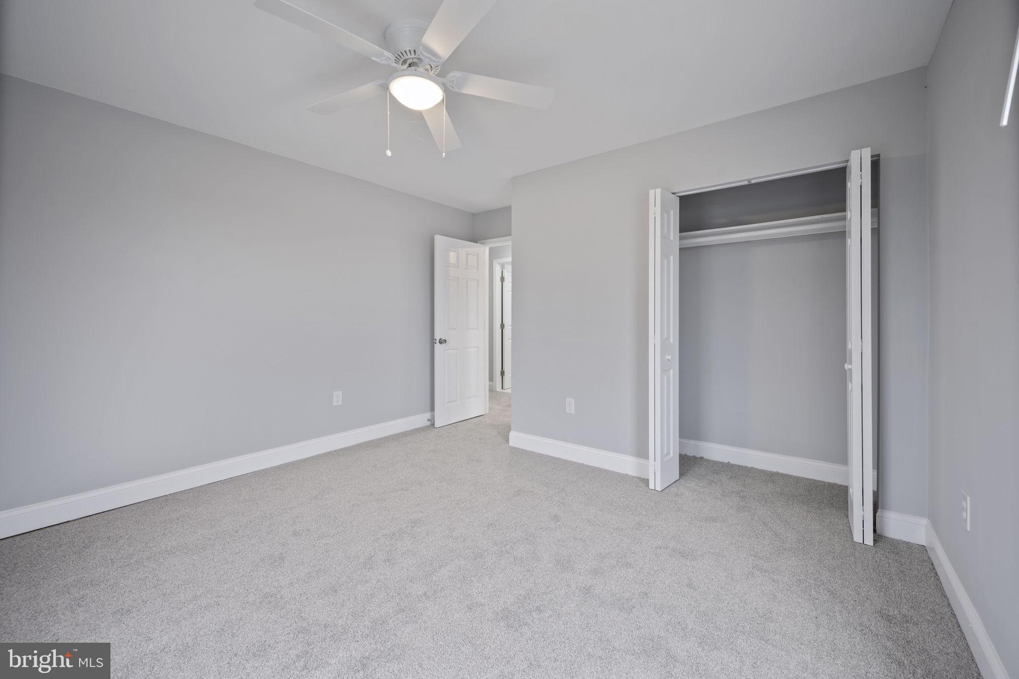 511 Riverside Drive Baltimore, MD 21221 - Photo 24 of 39 an empty room with a ceiling fan and a window