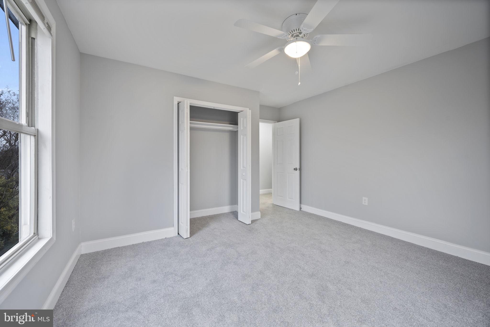 511 Riverside Drive Baltimore, MD 21221 - Photo 28 of 39 an empty room with closet and a ceiling fan