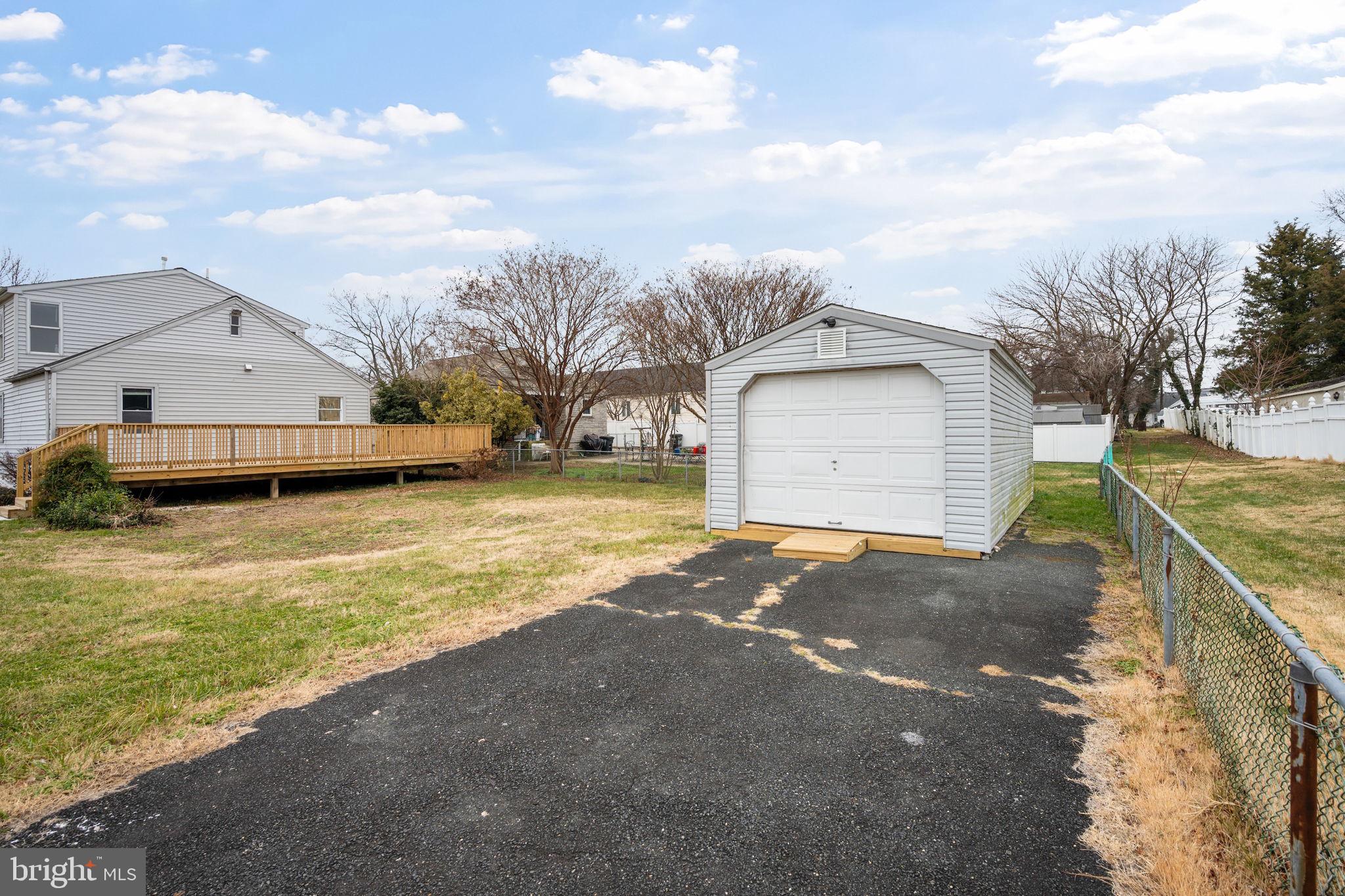 511 Riverside Drive Baltimore, MD 21221 - Photo 32 of 39 a view of a house with a yard and garage