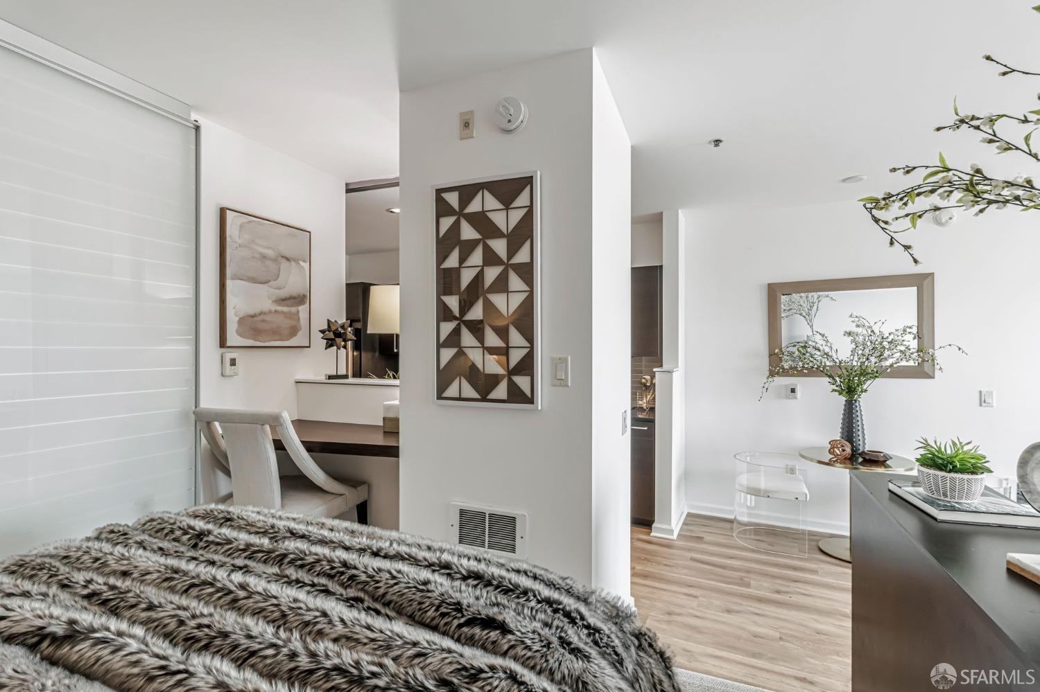 200 2nd Street, Unit 408 Oakland, CA 94607 - Photo 19 of 29 a bedroom with a bed and a dresser with wooden floor