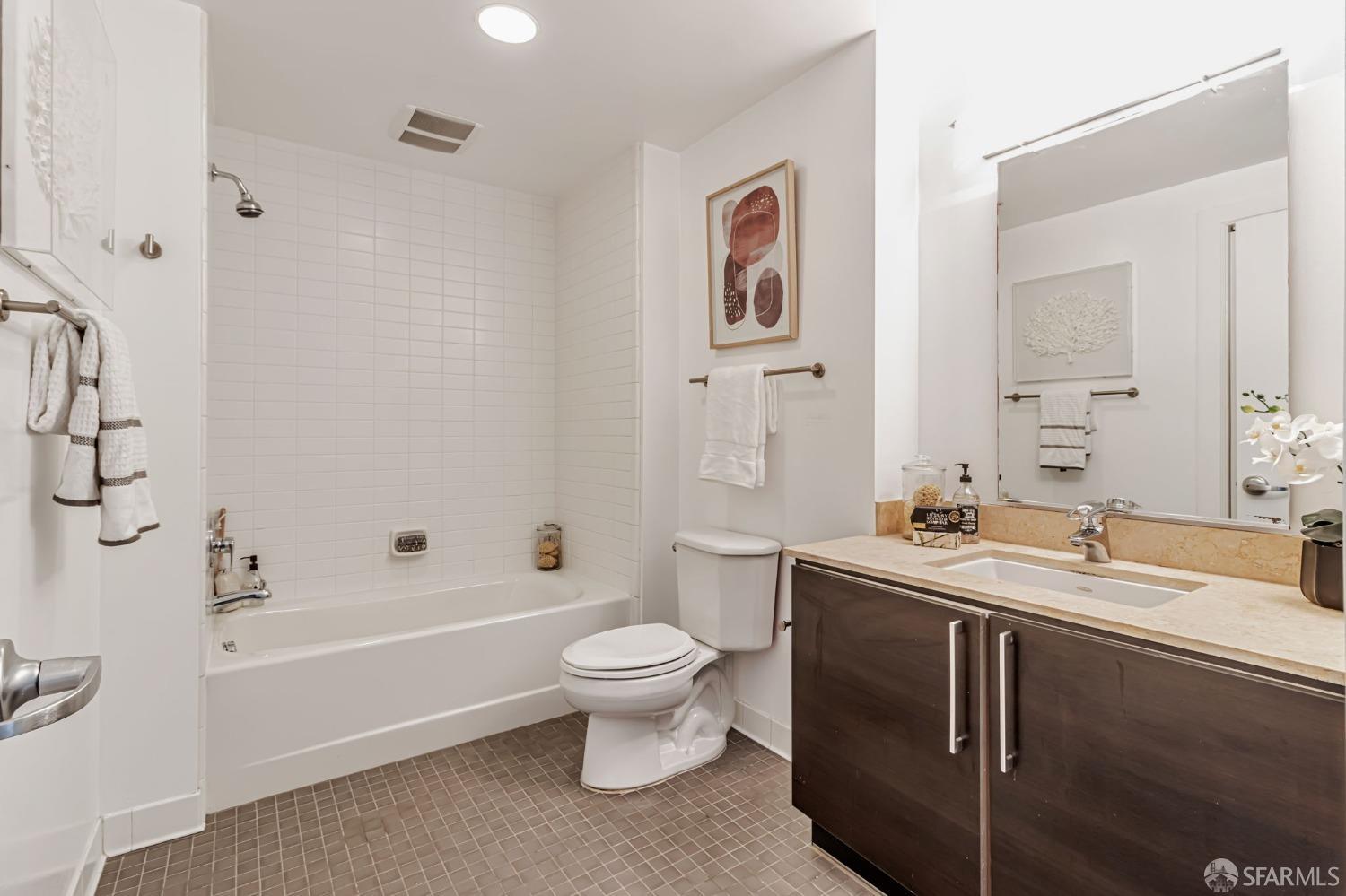 200 2nd Street, Unit 408 Oakland, CA 94607 - Photo 22 of 29 a bathroom with a double vanity sink toilet and shower