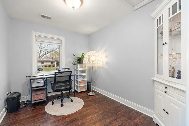 a view of a workspace with furniture and a window