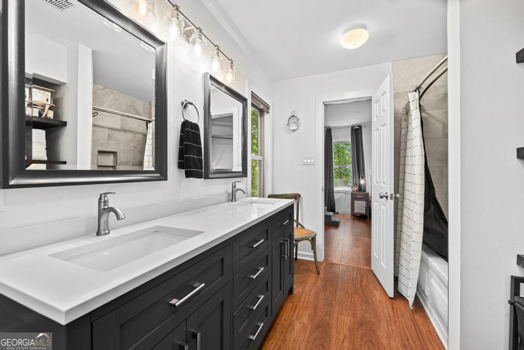585 John Fleming Road Hartwell, GA 30643 - Photo 32 of 59 a en suite bathroom with a double vanity sink and a mirror