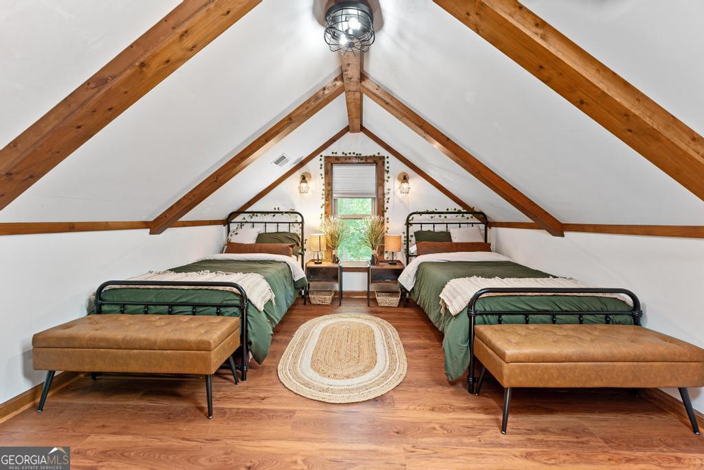 585 John Fleming Road Hartwell, GA 30643 - Photo 35 of 59 a bedroom with two beds and a chandelier