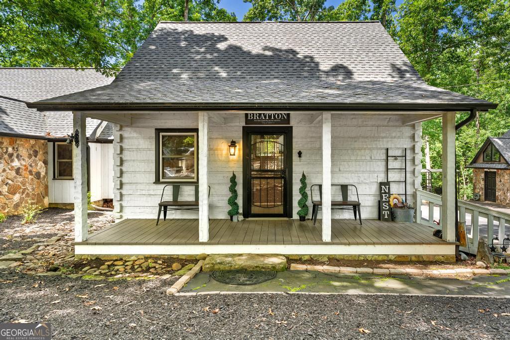 585 John Fleming Road Hartwell, GA 30643 - Photo 6 of 59 a view of a white house with large windows and plants