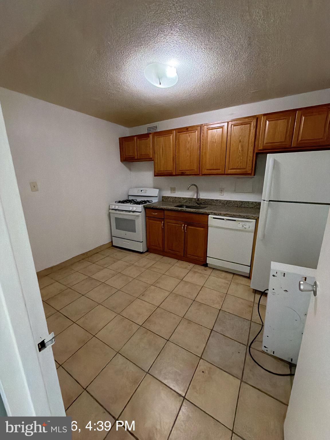 1836 Metzerott Road, Unit 1903 Hyattsville, MD 20783 - Photo 3 of 4 a kitchen with stainless steel appliances a stove a sink and a refrigerator