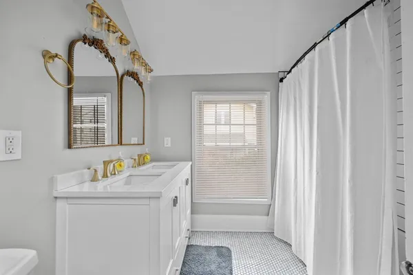 a bedroom with bed and a window
