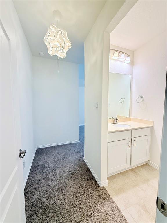 1336 Morning View Road Georgetown, TX 78628 - Photo 26 of 40 A well-lit interior hallway leads to a vanity area, showcasing practical living spaces.