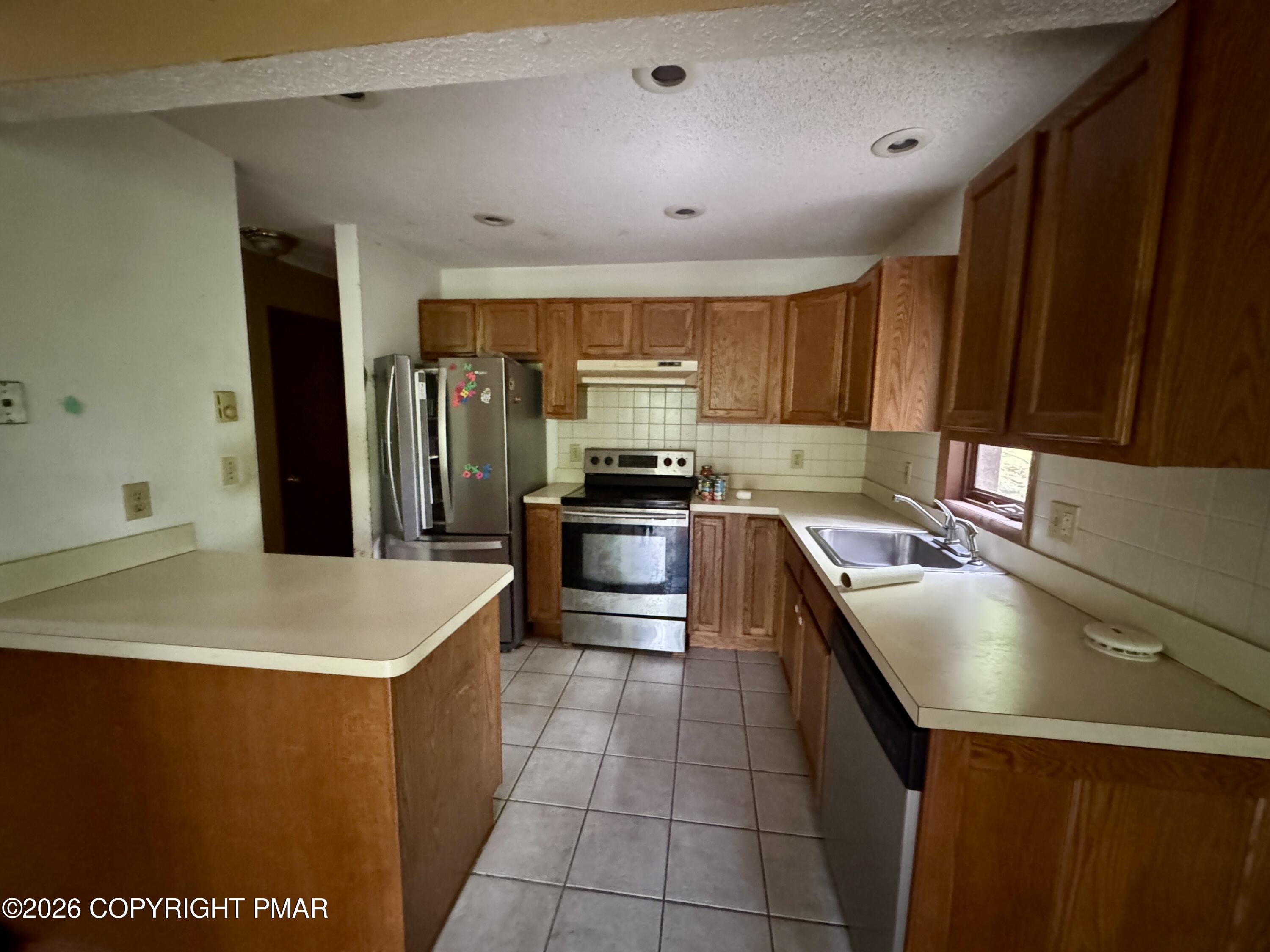 119 Durham Drive Bushkill, PA 18324 - Photo 32 of 41 a kitchen with a sink a stove top oven and cabinetry