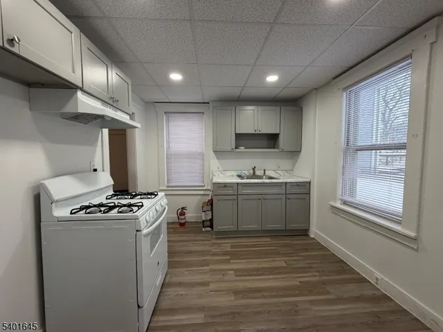 a kitchen with stainless steel appliances a stove a sink and a refrigerator