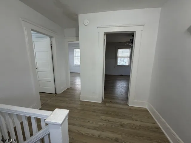 a view of hallway with wooden floor