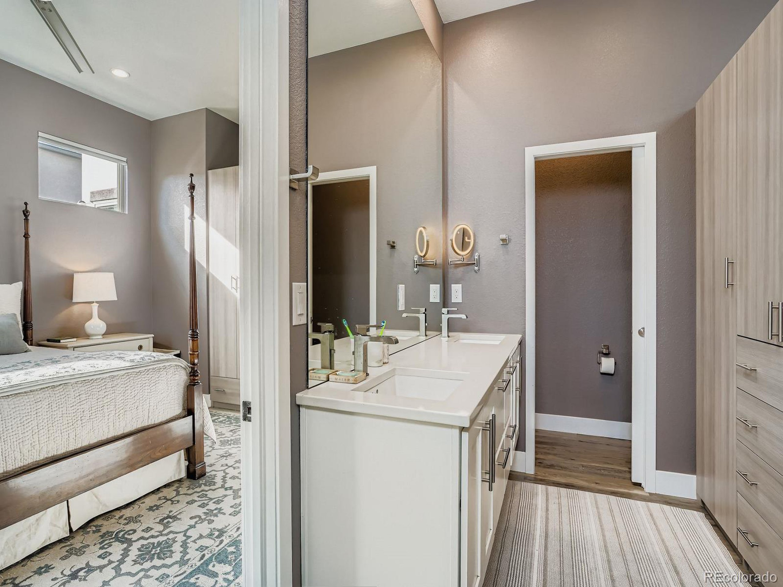 15506 W Lane Lakewood, CO 80228 - Photo 14 of 37 a en suite bathroom with a double vanity sink and a mirror