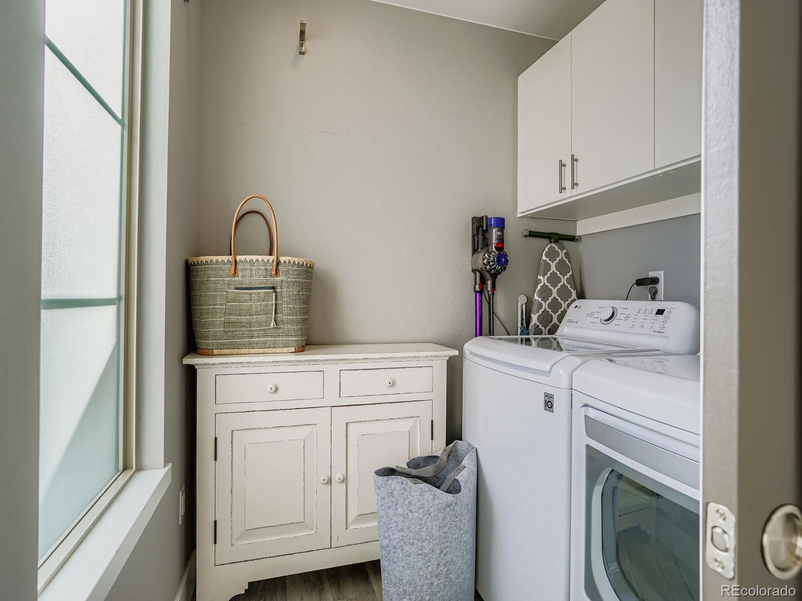 15506 W Lane Lakewood, CO 80228 - Photo 17 of 37 a view of washer and dryer with kitchen in the background