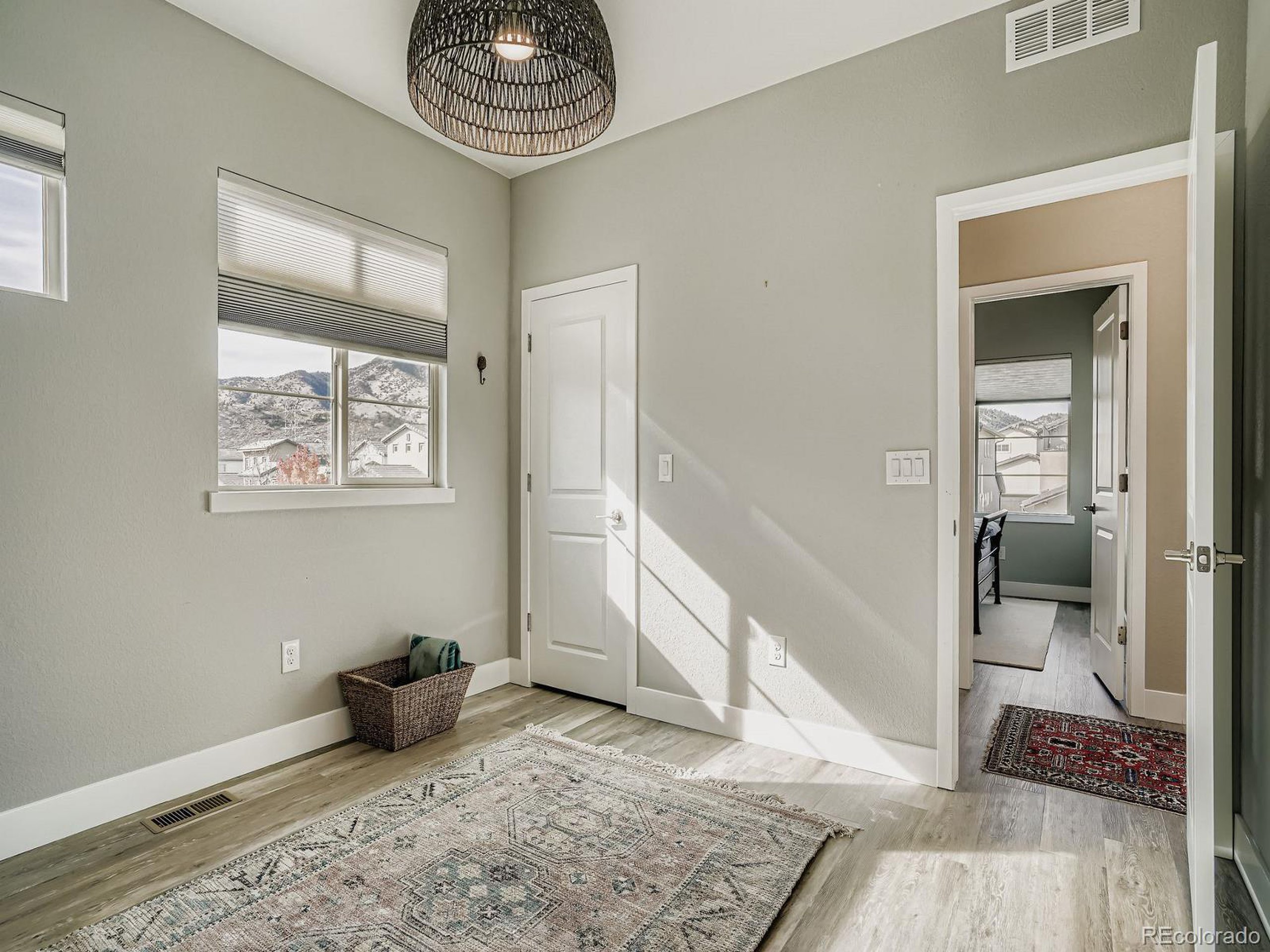 15506 W Lane Lakewood, CO 80228 - Photo 24 of 37 a view of a hallway with wooden floor and a livingroom view